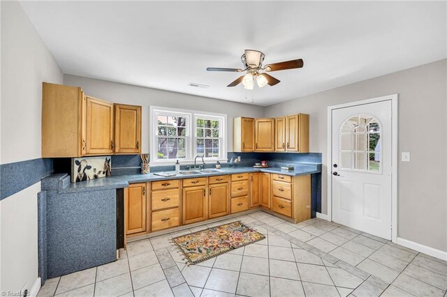 kitchen with ceiling fan, sink, light tile patterned floors, and tasteful backsplash