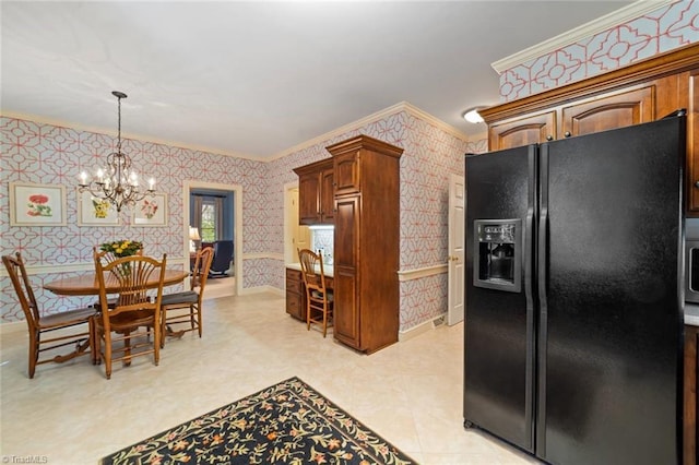 kitchen with an inviting chandelier, ornamental molding, black fridge, and wallpapered walls