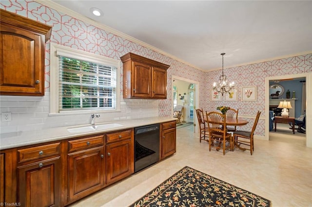kitchen with crown molding, a sink, an inviting chandelier, black dishwasher, and wallpapered walls