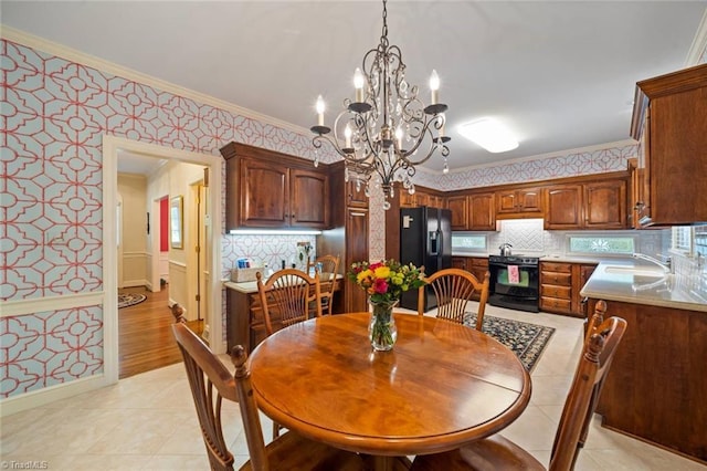 dining room with crown molding, wallpapered walls, a chandelier, and light tile patterned floors