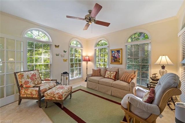 tiled living area with crown molding and a ceiling fan