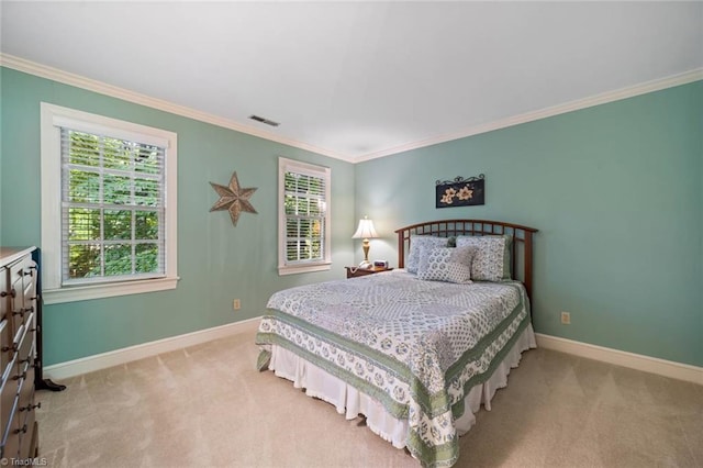 bedroom with crown molding, baseboards, visible vents, and carpet floors