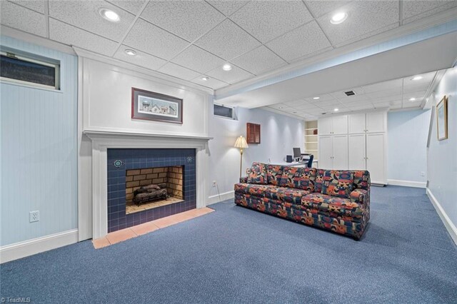 living room with recessed lighting, baseboards, dark carpet, and a tile fireplace