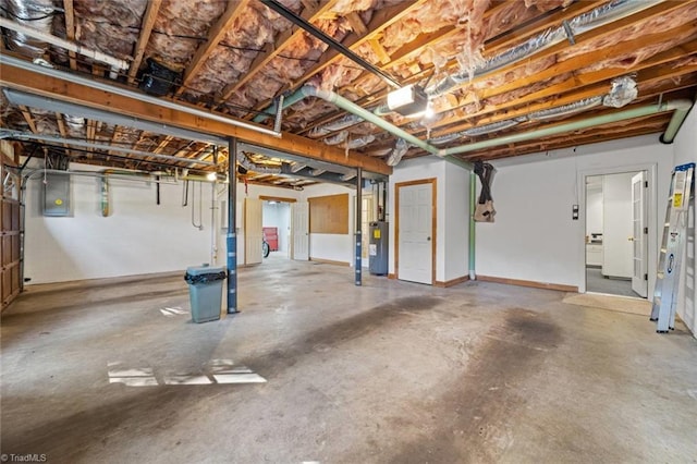 unfinished below grade area featuring water heater and electric panel