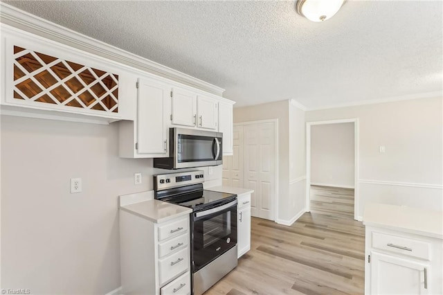 kitchen featuring a textured ceiling, light hardwood / wood-style flooring, stainless steel appliances, and white cabinets