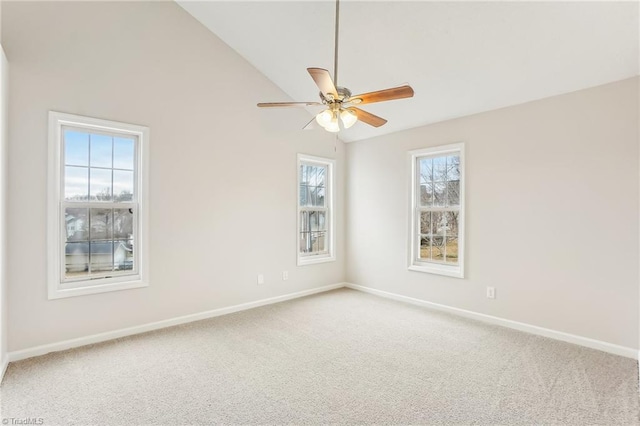 spare room with ceiling fan, vaulted ceiling, and carpet