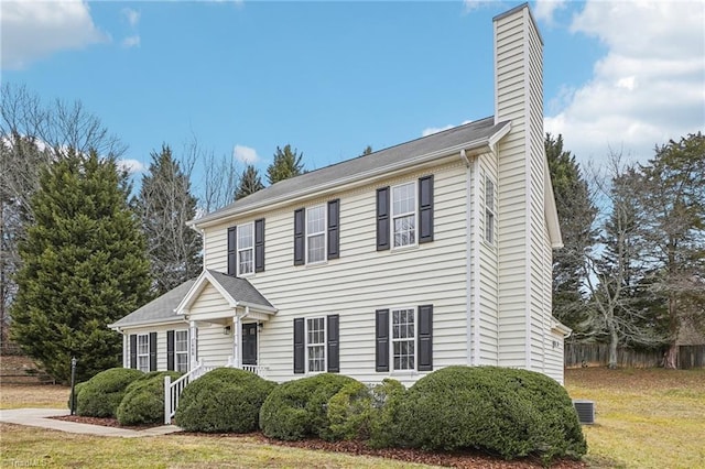 view of front of home with a front yard and central air condition unit