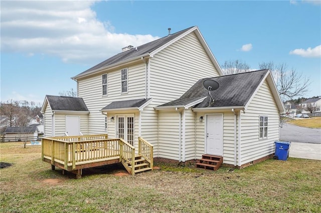 back of property with a wooden deck and a yard