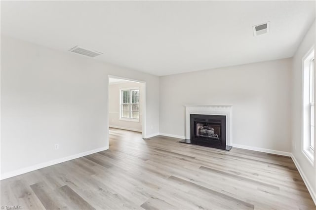 unfurnished living room featuring light hardwood / wood-style flooring