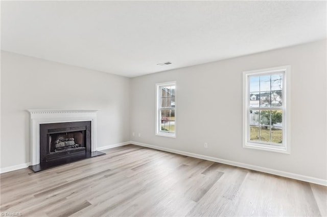 unfurnished living room with light wood-type flooring