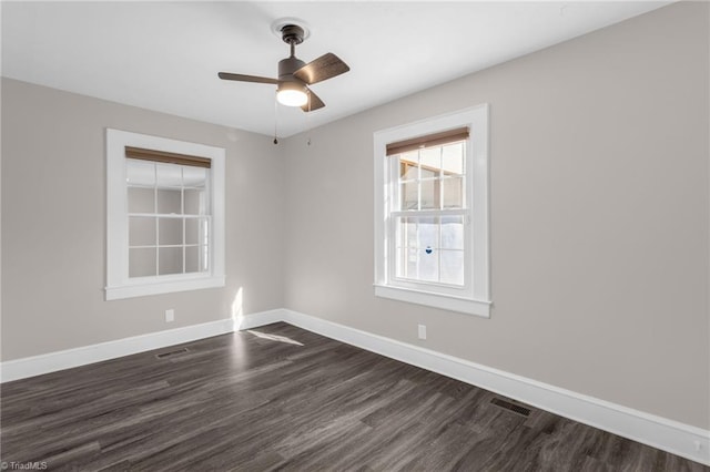 unfurnished room with ceiling fan and dark wood-type flooring