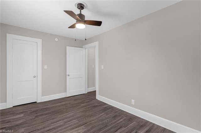 unfurnished bedroom with ceiling fan and dark wood-type flooring