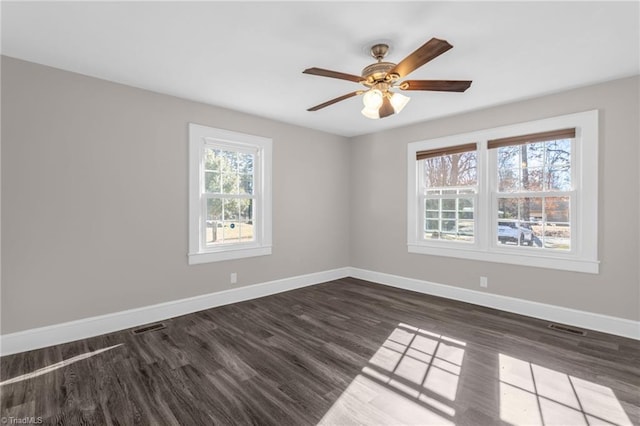 empty room featuring ceiling fan and dark wood-type flooring