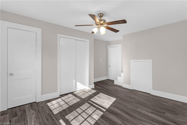 unfurnished bedroom featuring ceiling fan and dark hardwood / wood-style floors