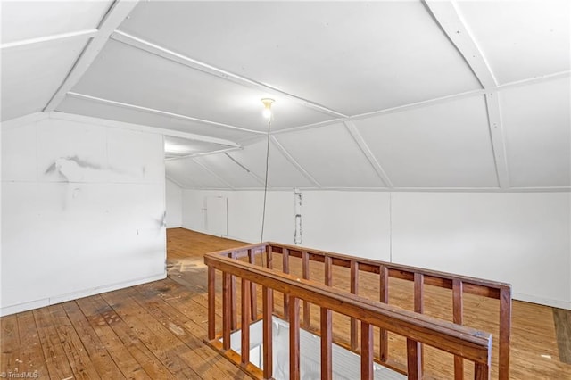 additional living space featuring hardwood / wood-style flooring and vaulted ceiling