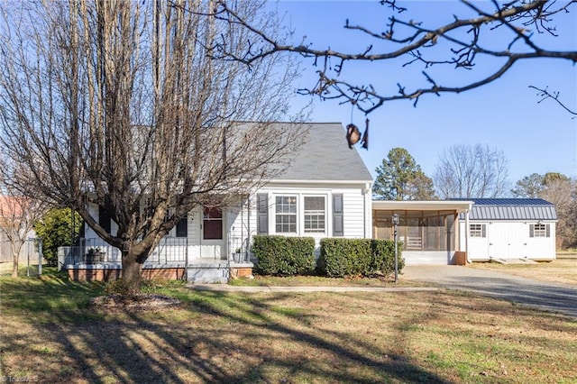 view of front of property with a front yard and a carport