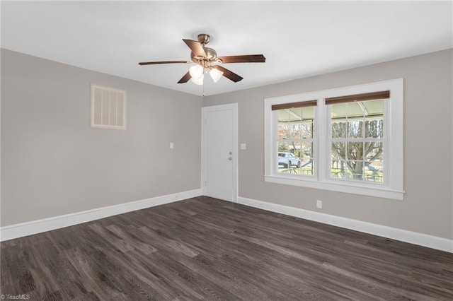 spare room featuring ceiling fan and dark hardwood / wood-style flooring