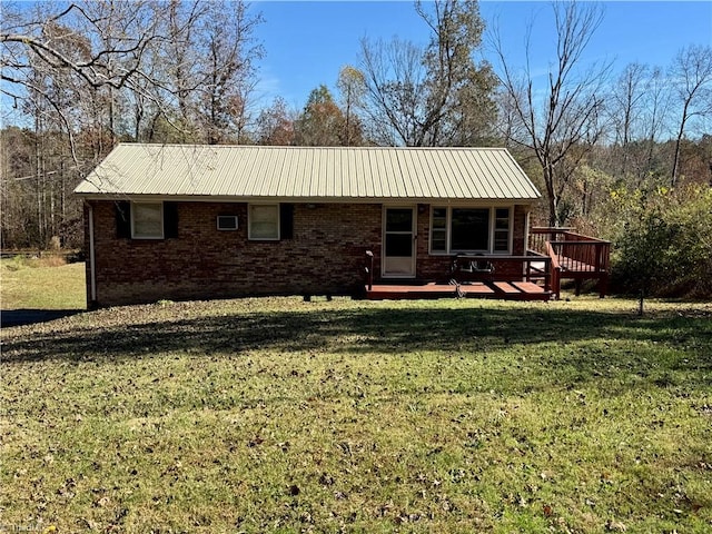 back of house with a yard and a wooden deck