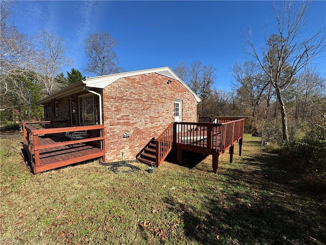 view of side of home featuring a yard and a deck