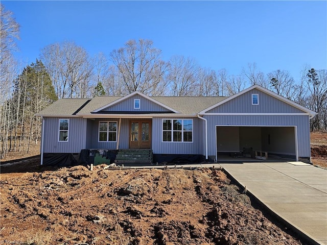 ranch-style house with french doors and a garage