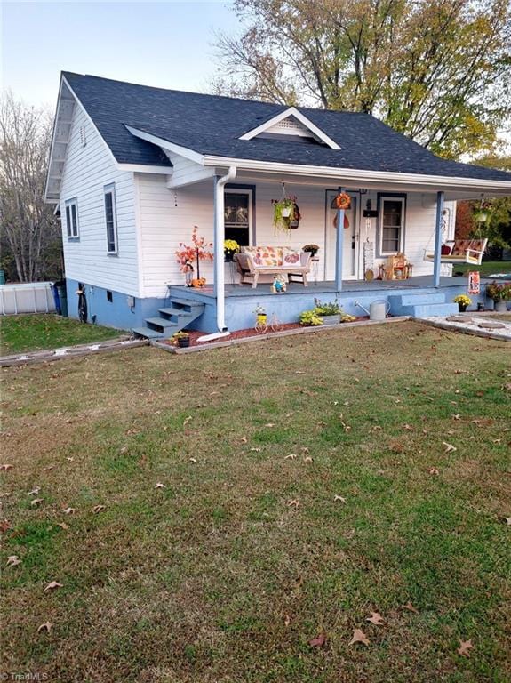 ranch-style house featuring a front yard and a porch