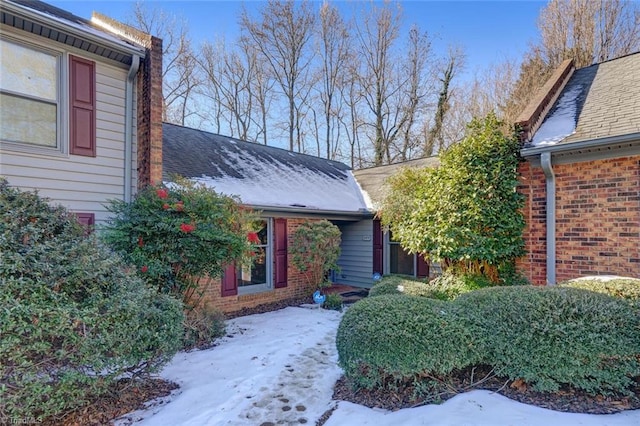 view of snow covered property entrance