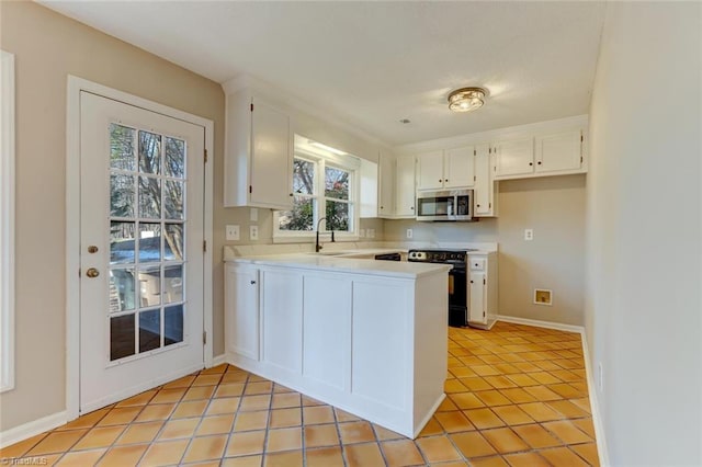 kitchen featuring white cabinets, black / electric stove, and sink