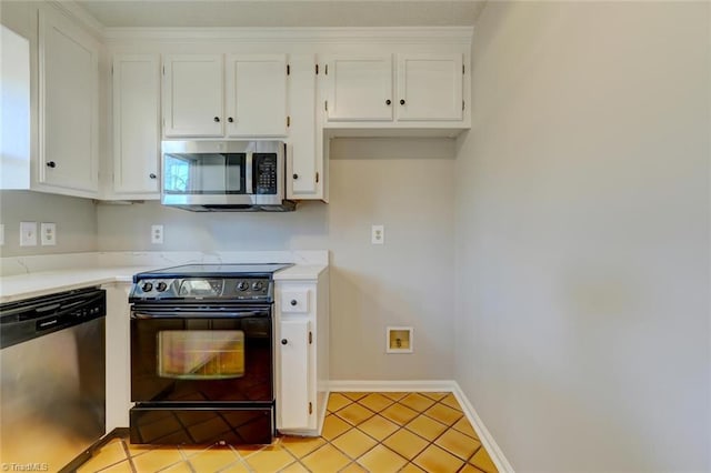 kitchen featuring light tile patterned flooring, stainless steel appliances, and white cabinetry