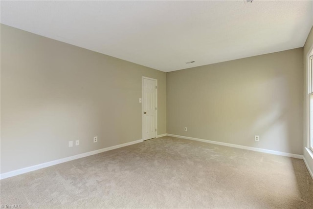 unfurnished room with light carpet