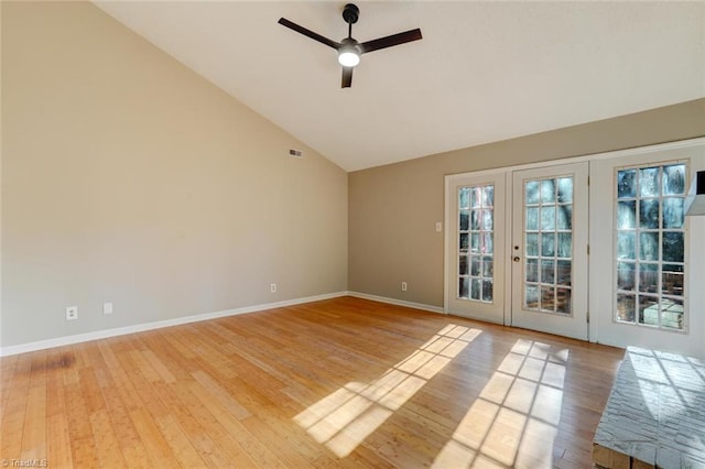 unfurnished room featuring french doors, ceiling fan, wood-type flooring, and high vaulted ceiling