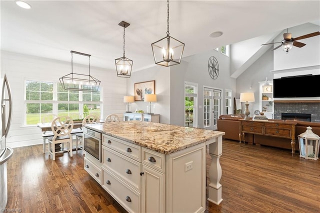 3922 Tam O Shanter Rd, Kernersville, NC 27284 - kitchen with dark wood-style floors, a center island, open floor plan, light stone countertops, and high vaulted ceiling