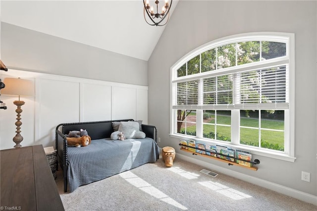 3922 Tam O Shanter Rd, Kernersville, NC 27284 - carpeted bedroom with a chandelier, a decorative wall, and high vaulted ceiling