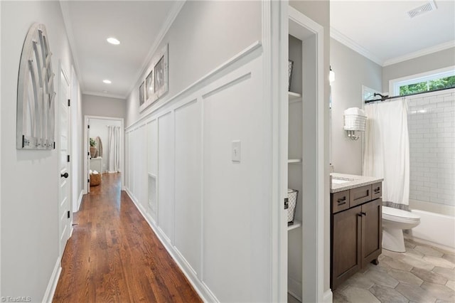 3922 Tam O Shanter Rd, Kernersville, NC 27284 - corridor with crown molding, recessed lighting, wood finished floors, and built in shelves