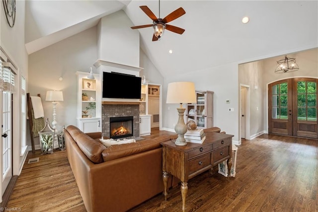 3922 Tam O Shanter Rd, Kernersville, NC 27284 - living area featuring french doors, high vaulted ceiling, ceiling fan, a fireplace, and wood finished floors
