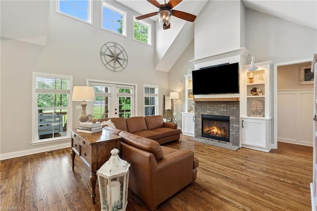 3922 Tam O Shanter Rd, Kernersville, NC 27284 - living room with a high ceiling, a ceiling fan, a fireplace, french doors, and plenty of natural light