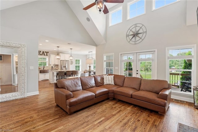 3922 Tam O Shanter Rd, Kernersville, NC 27284 - living room with high vaulted ceiling, light wood-style floors, ceiling fan, and healthy amount of natural light