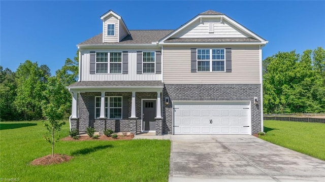 6617 Grogan Hill Rd, Whitsett, NC 27249 - view of front of home with concrete driveway, a front yard, an attached garage, and brick siding