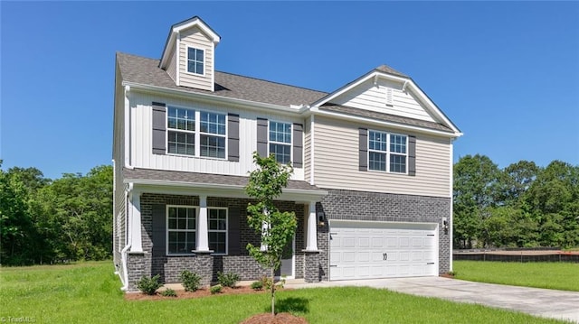 6617 Grogan Hill Rd, Whitsett, NC 27249 - view of front of property with a front yard, driveway, a garage, and brick siding