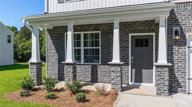 6617 Grogan Hill Rd, Whitsett, NC 27249 - entrance to property featuring a porch, board and batten siding, stone siding, and brick siding