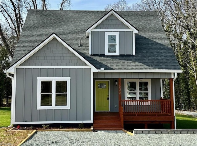 view of front of house with a porch, board and batten siding, and roof with shingles