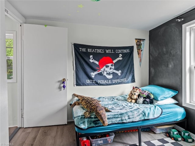 bedroom with hardwood / wood-style floors