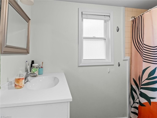 bathroom featuring walk in shower and vanity