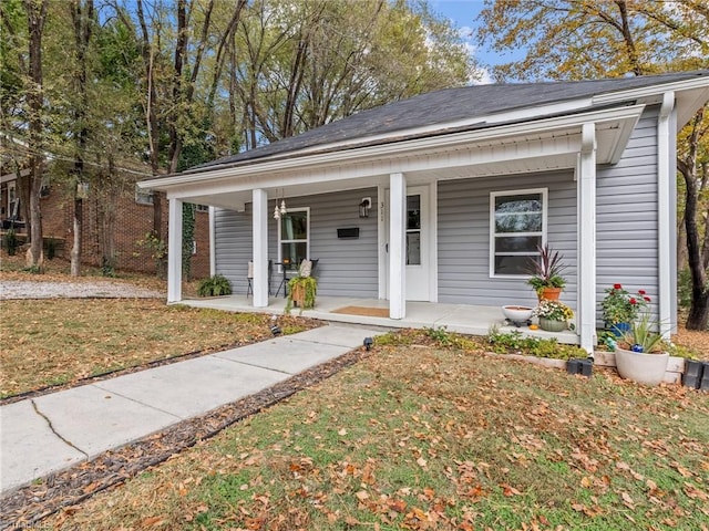 view of front of house with a front lawn and covered porch