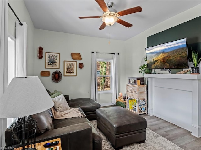 living room featuring hardwood / wood-style flooring and ceiling fan