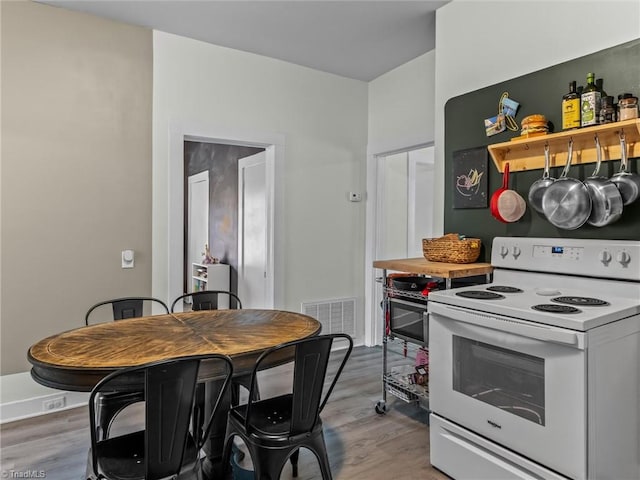 kitchen with wood-type flooring and electric stove