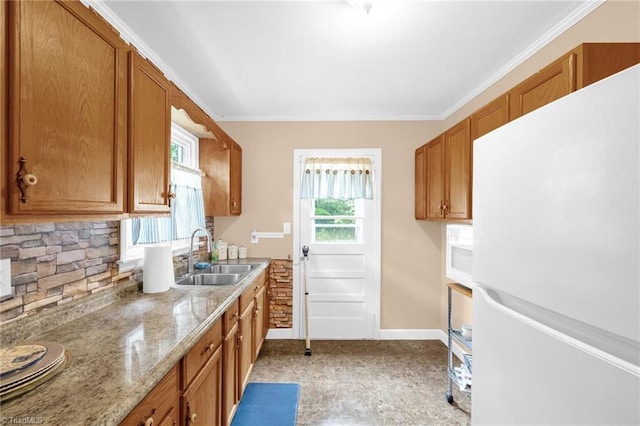 109 Easy St, Providence, NC 27315 - kitchen with freestanding refrigerator, a sink, and brown cabinets