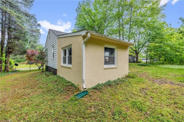 109 Easy St, Providence, NC 27315 - view of side of home featuring stucco siding and a lawn