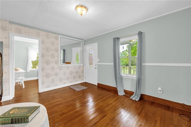 109 Easy St, Providence, NC 27315 - foyer entrance with wood-type flooring, a textured ceiling, baseboards, wallpapered walls, and ornamental molding