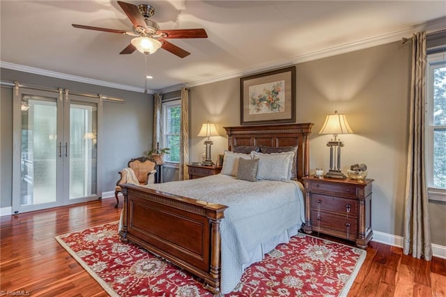 bedroom featuring french doors, ornamental molding, and hardwood / wood-style floors