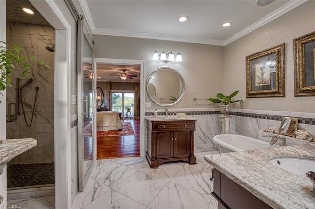 bathroom featuring vanity, crown molding, and separate shower and tub